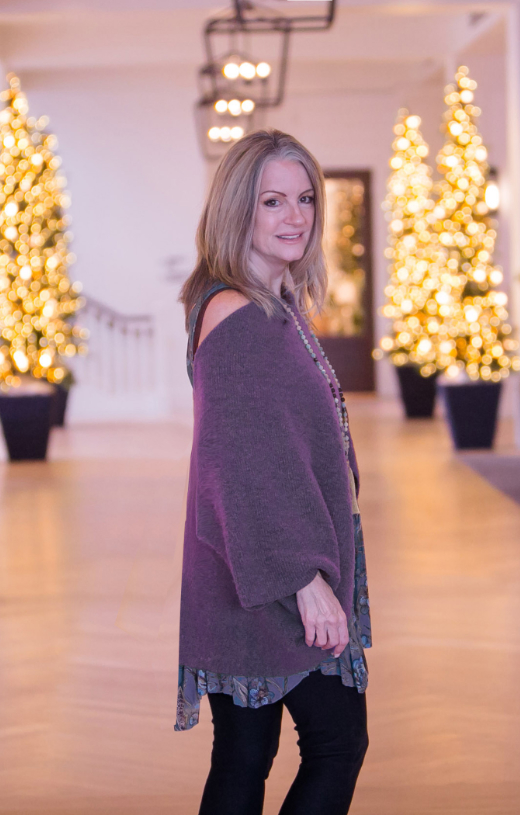 Vicki standing with tree lights in the background