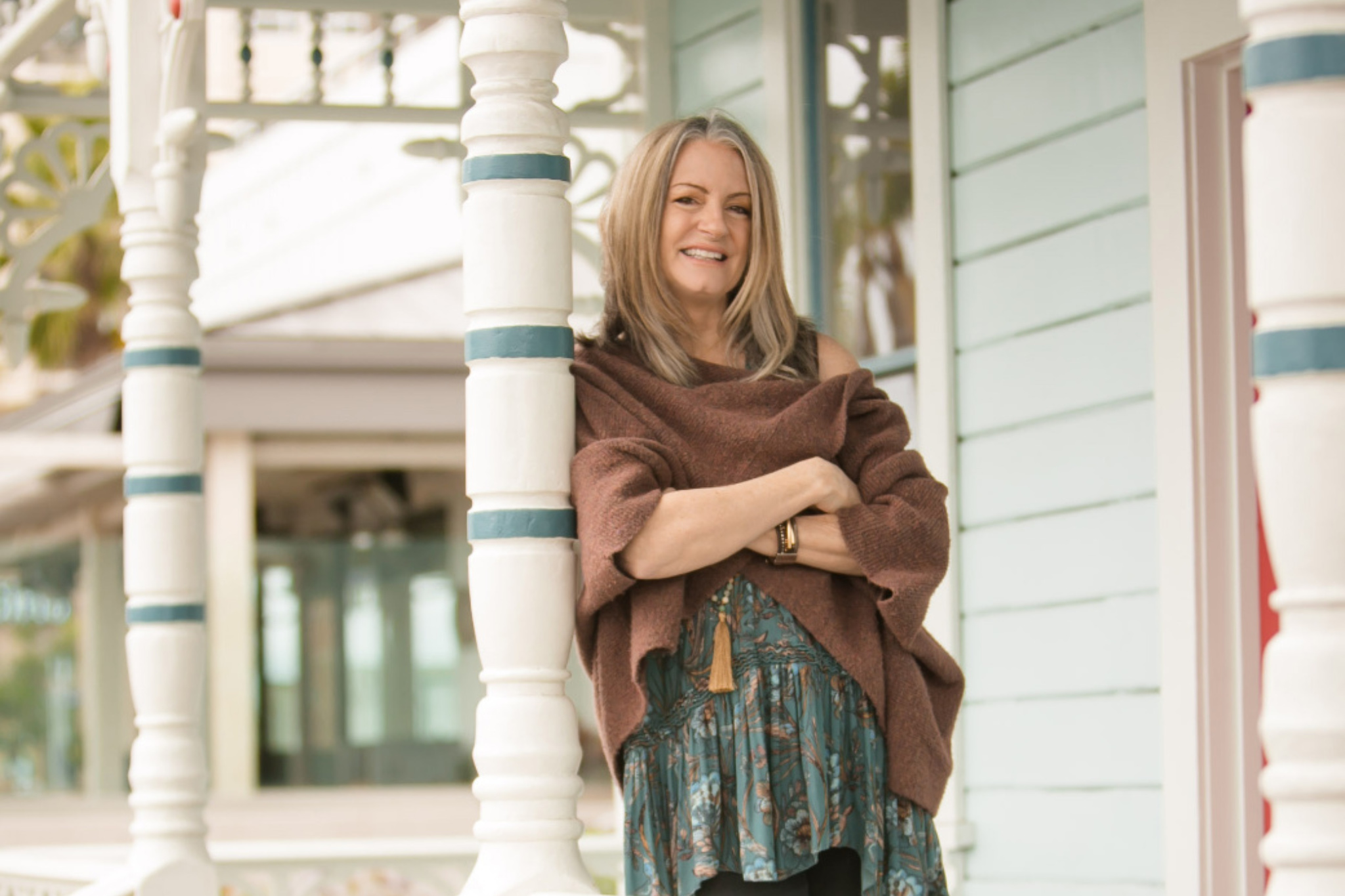 Vicki Murphy standing on porch with arms crossed